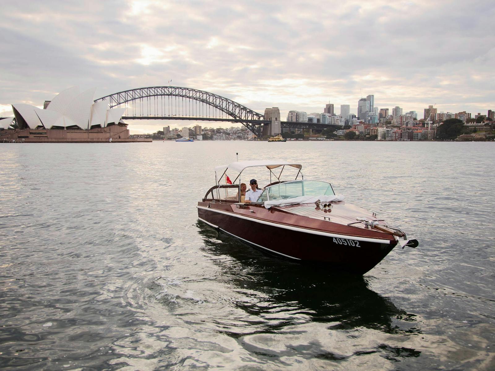 MV BEL private cruise on Sydney Harbour with Sydney city skyline and Harbour Bridge.