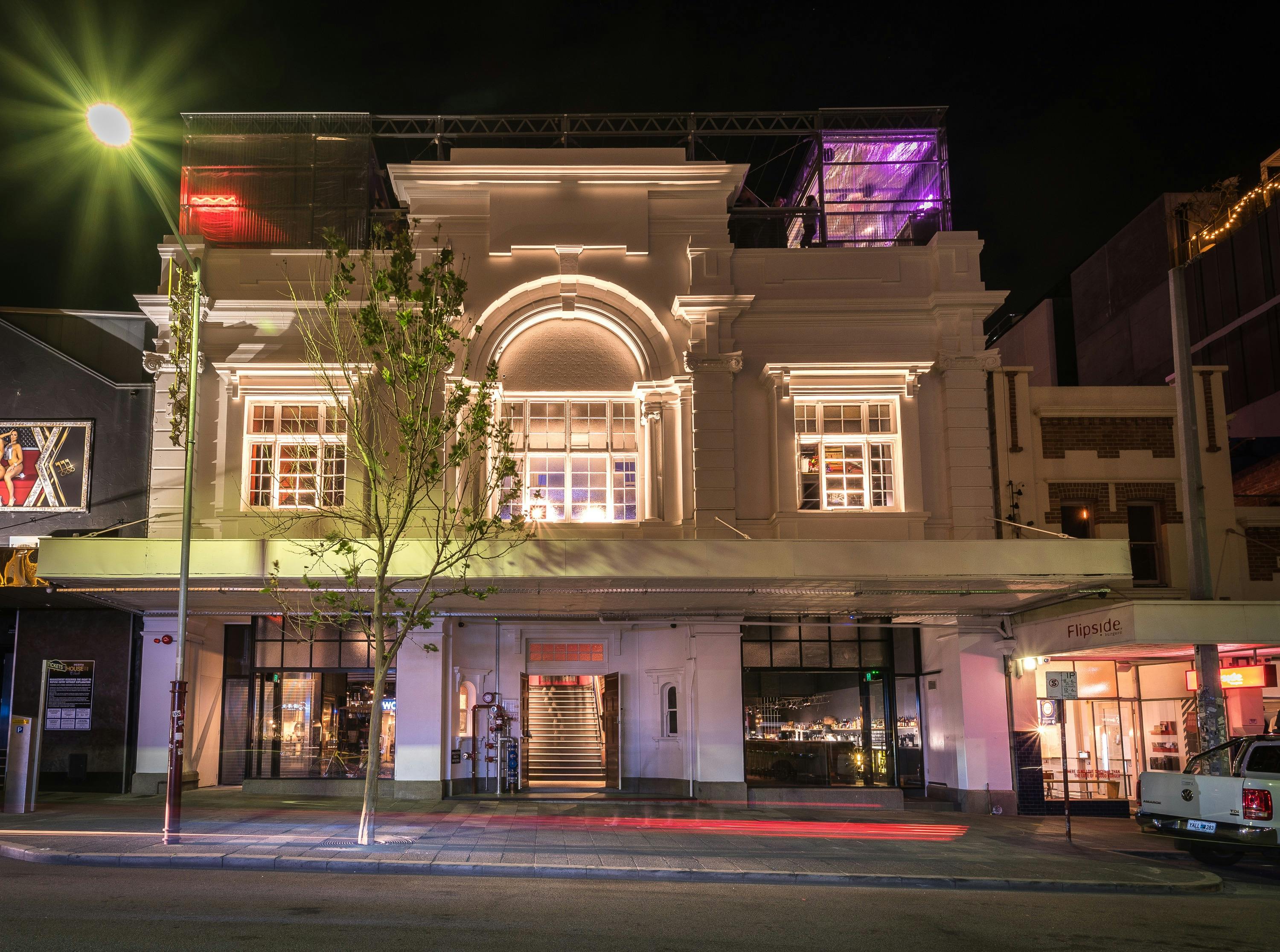 Hello Rooftop emits a purple glow on top of the century-old beauty of The Rechabite building.