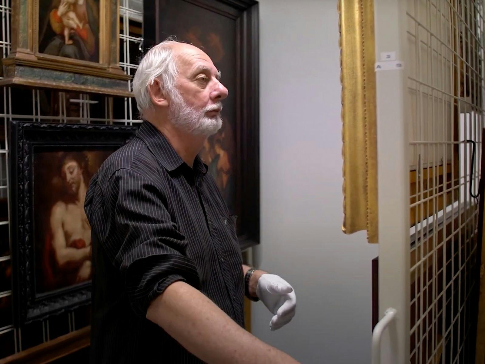 Senior Curator inside collections room with artwork