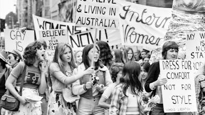 Black and white photograph of a group of people protesting at a march