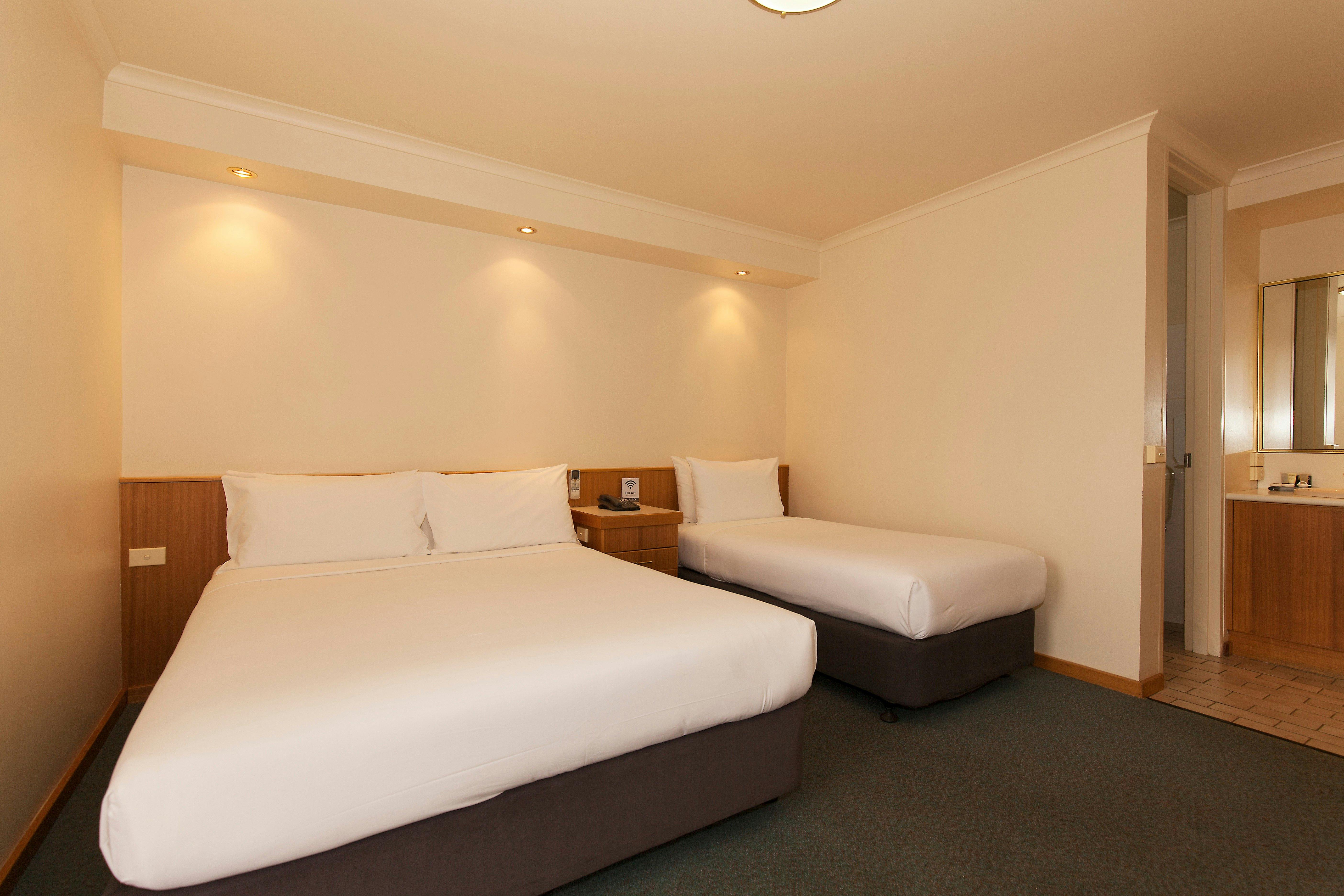 Generous Room containing a queen bed plus single. Desk, Wifi, table and chairs plus tea coffee.