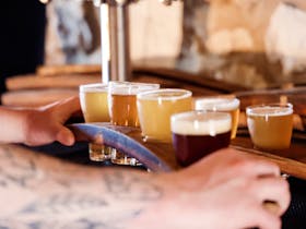 Hand delivering a tasting-paddle of Loophole Brewing Co. craft beer tasters at the Cape Jaffa Wines