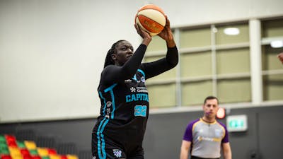 Basketball player shoots the ball.