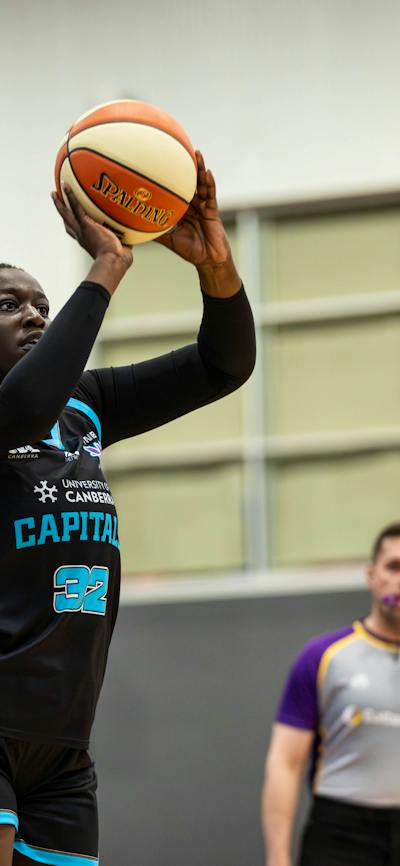 Basketball player shoots the ball.