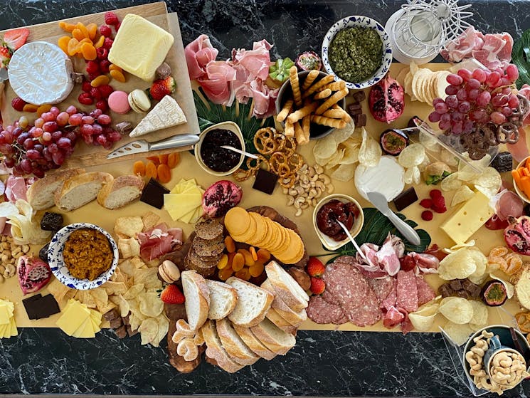 Delicious savoury grazing table curated with charcuterie, cheeses, dips, and homemade relishes.