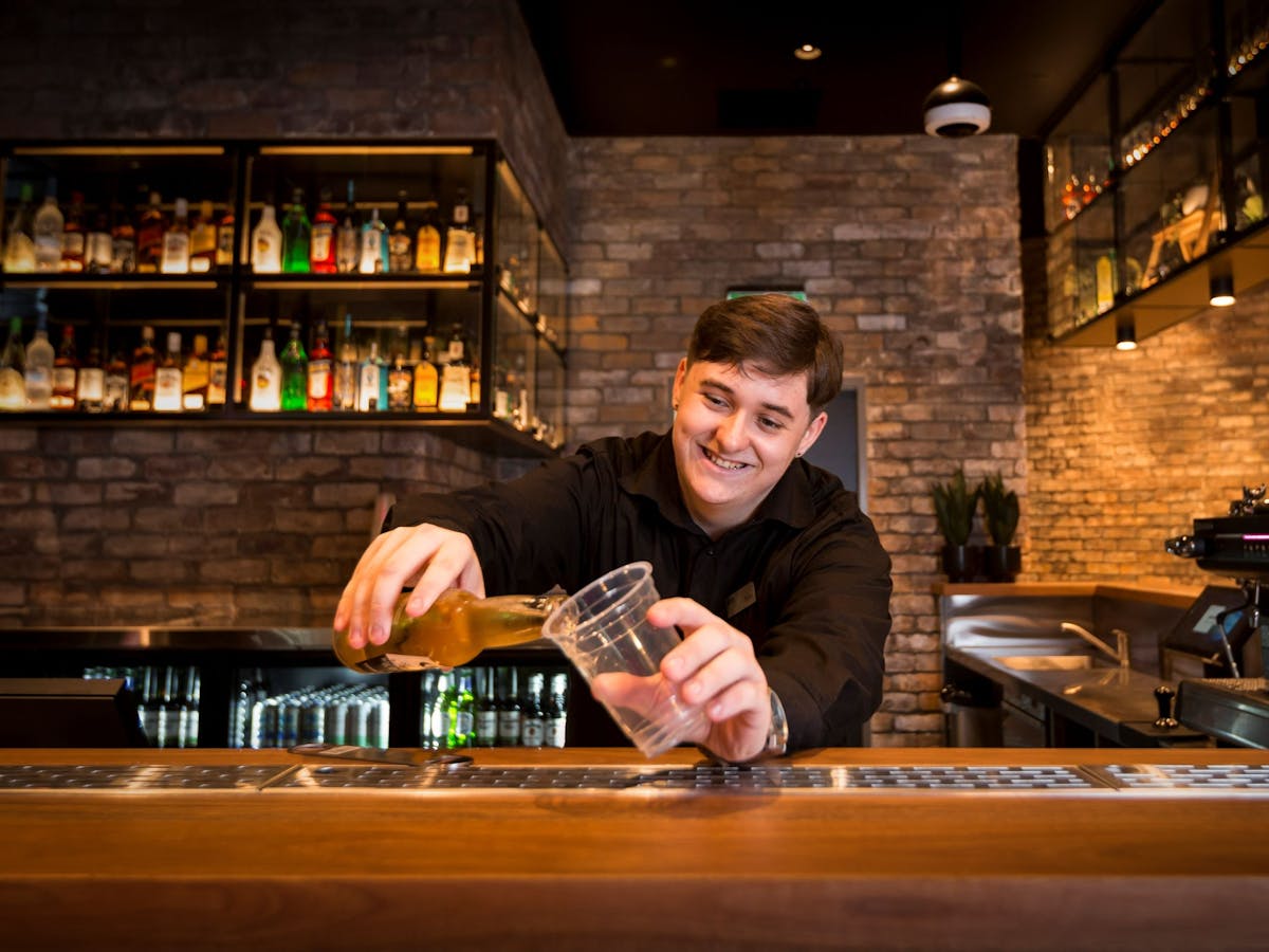 Person pouring a beer