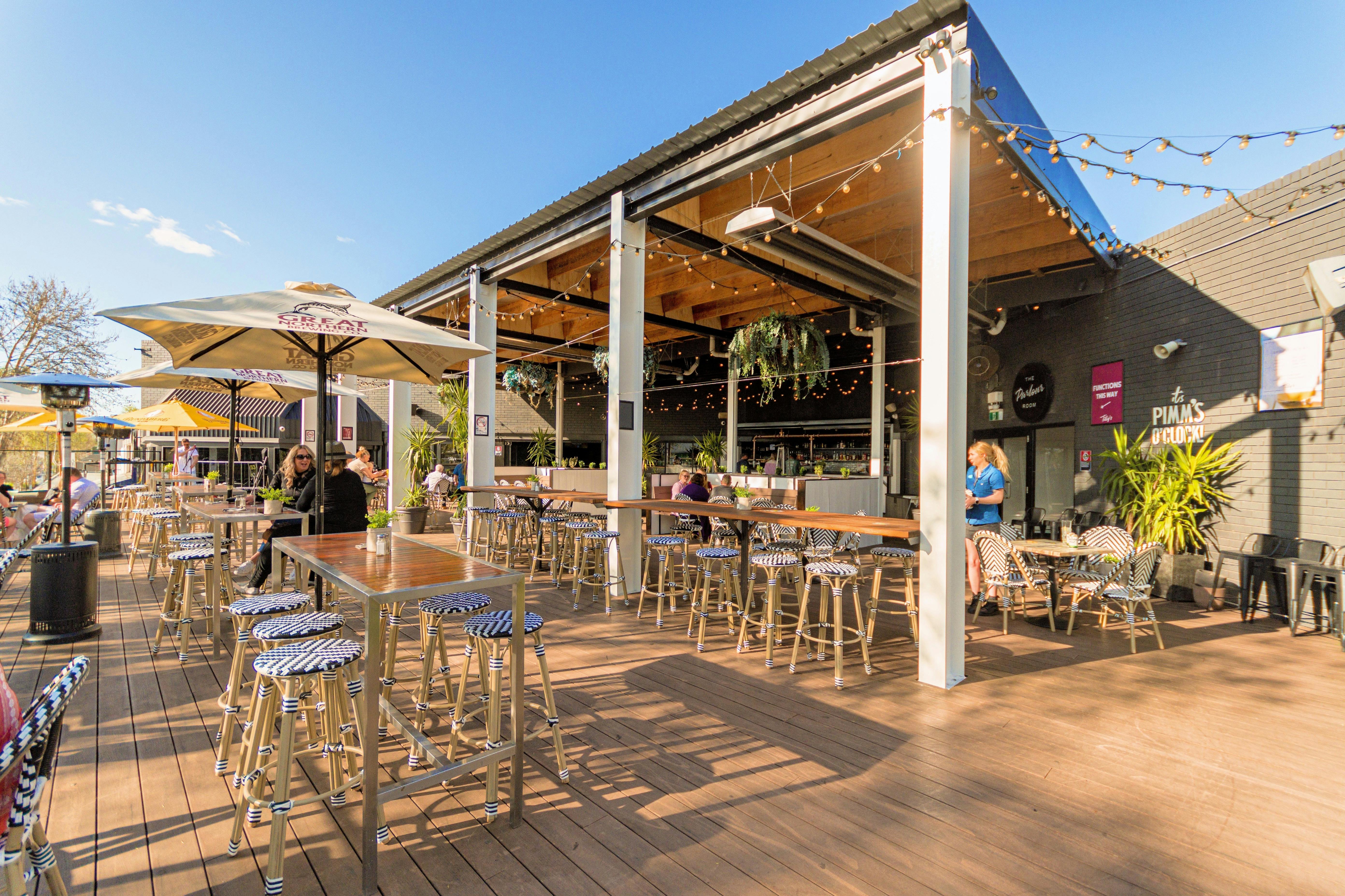 a photo of Tilly's deck with tables and chairs some undercover and some in the sun