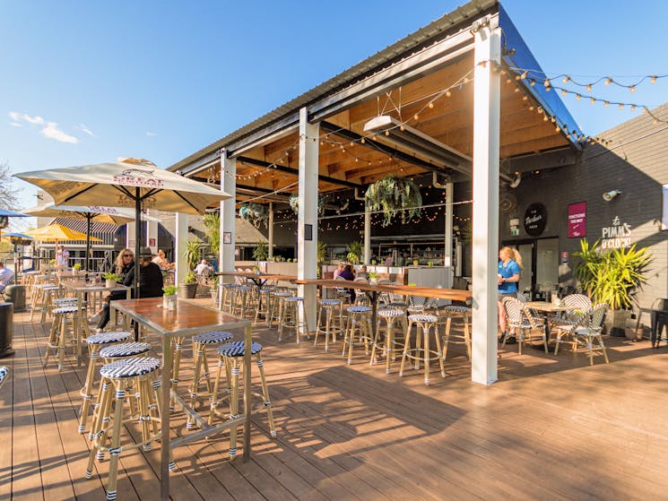 a photo of Tilly's deck with tables and chairs some undercover and some in the sun