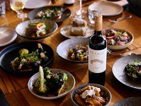A table filled with plates, wine glasses
