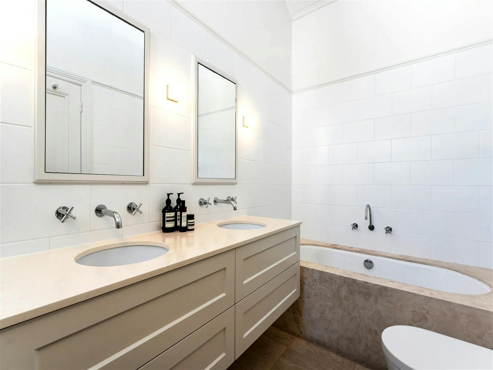 spacious travertine bathroom with underfloor heating as well as separate bath and shower