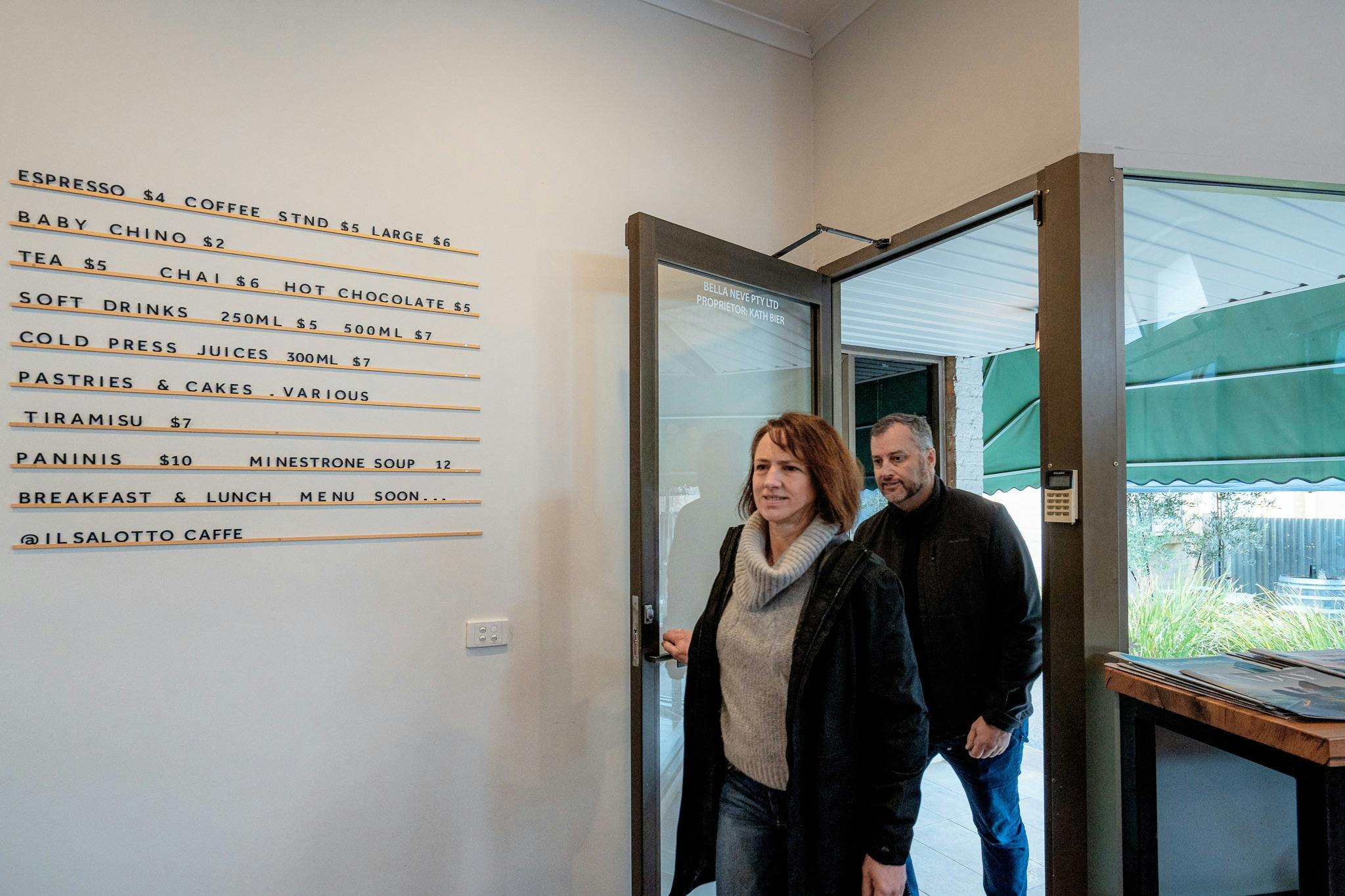 Two people walking through the door