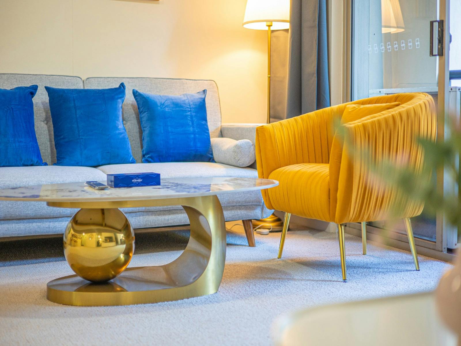 Living room with comfortable seating and a sofa bed, coffee table, and stylish accent chairs.