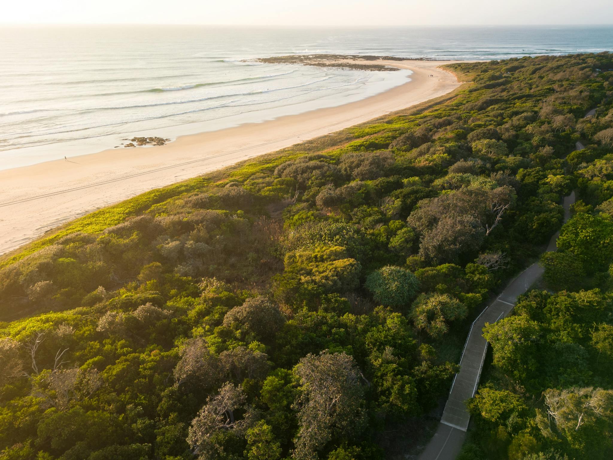 South end of Sharpes Beach towards Flat Rock with coast path in foreground