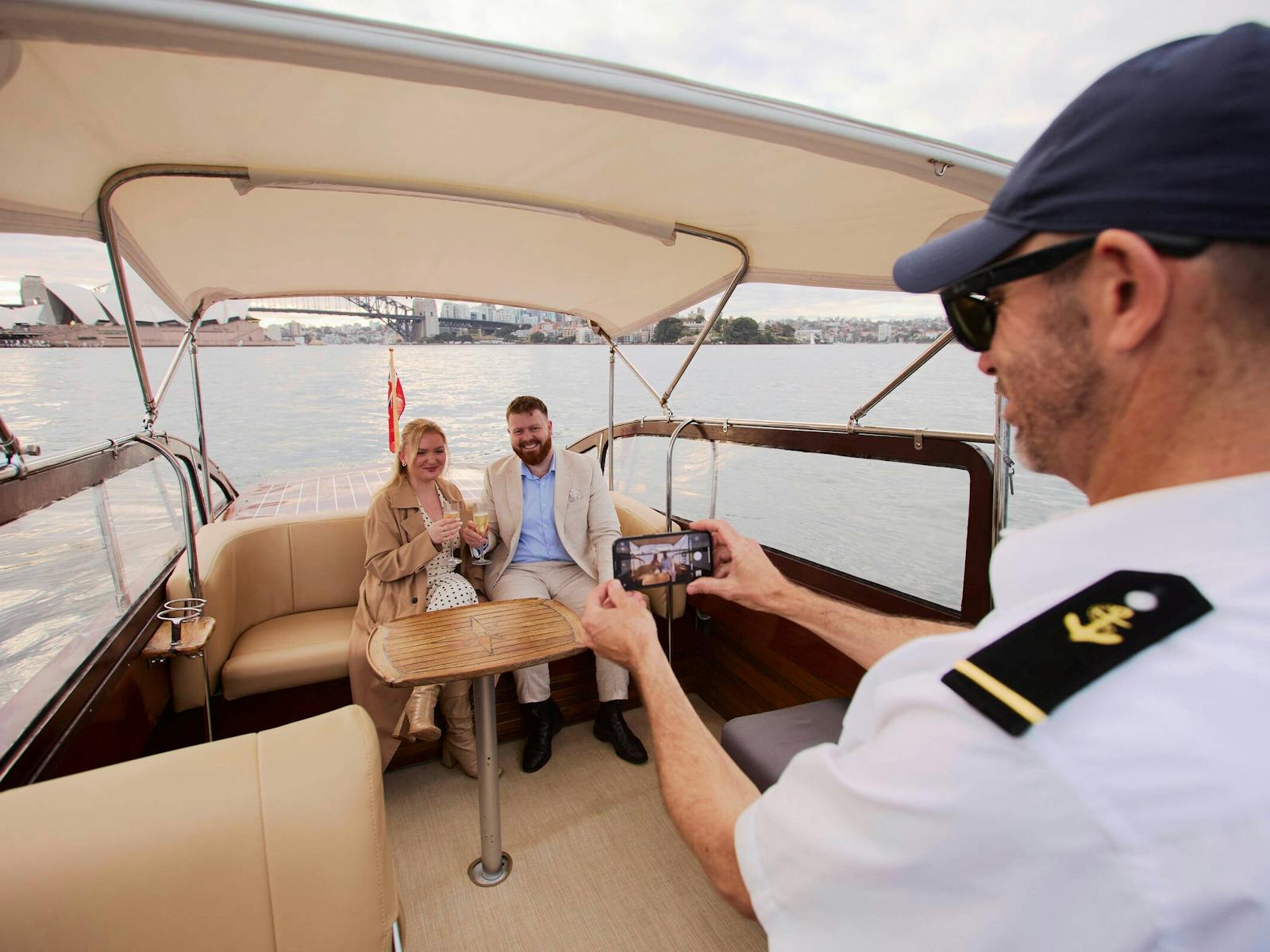 MV BEL private cruise on Sydney Harbour with Sydney city skyline and Harbour Bridge.