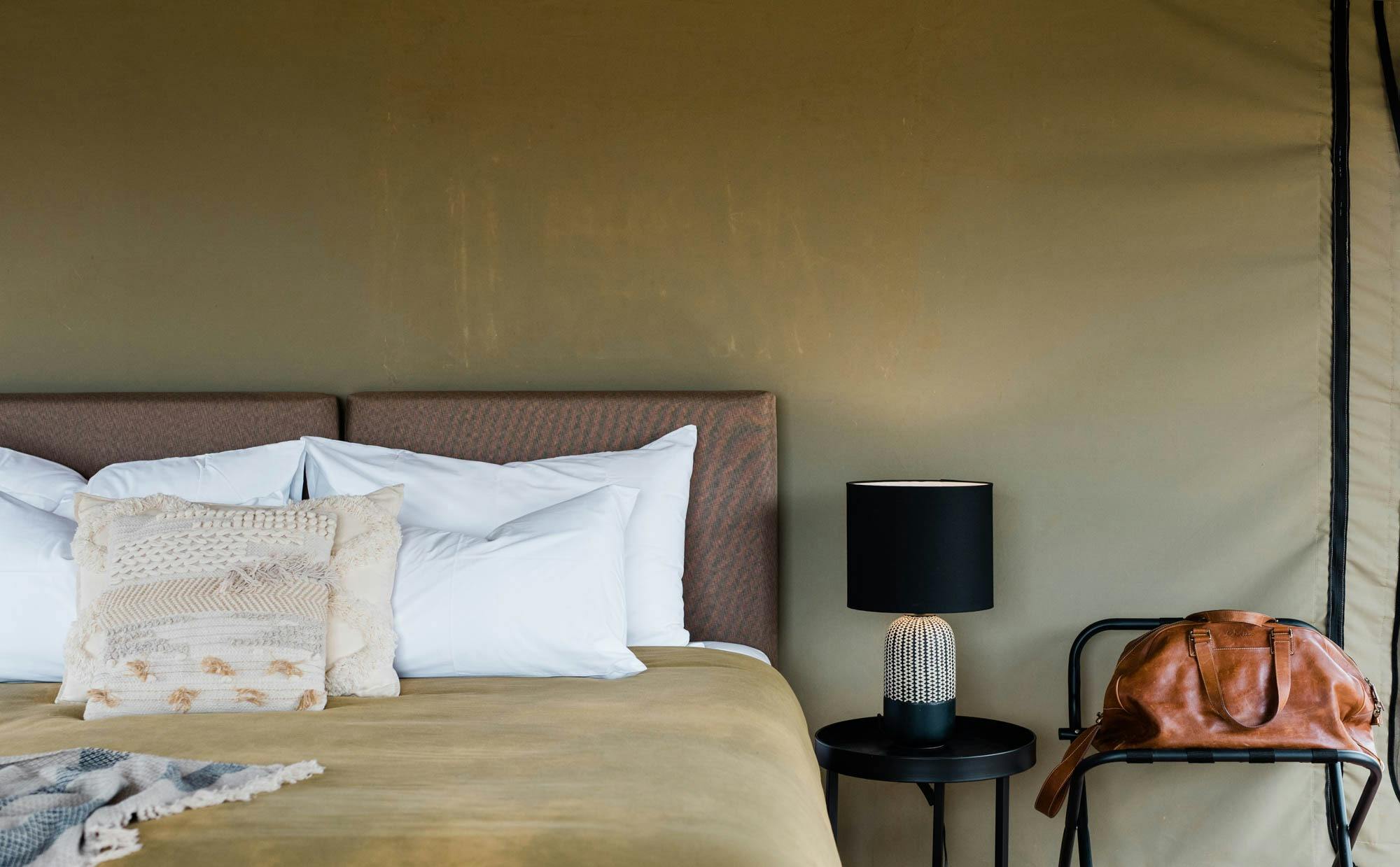 Bed with bedside lamp on beside it