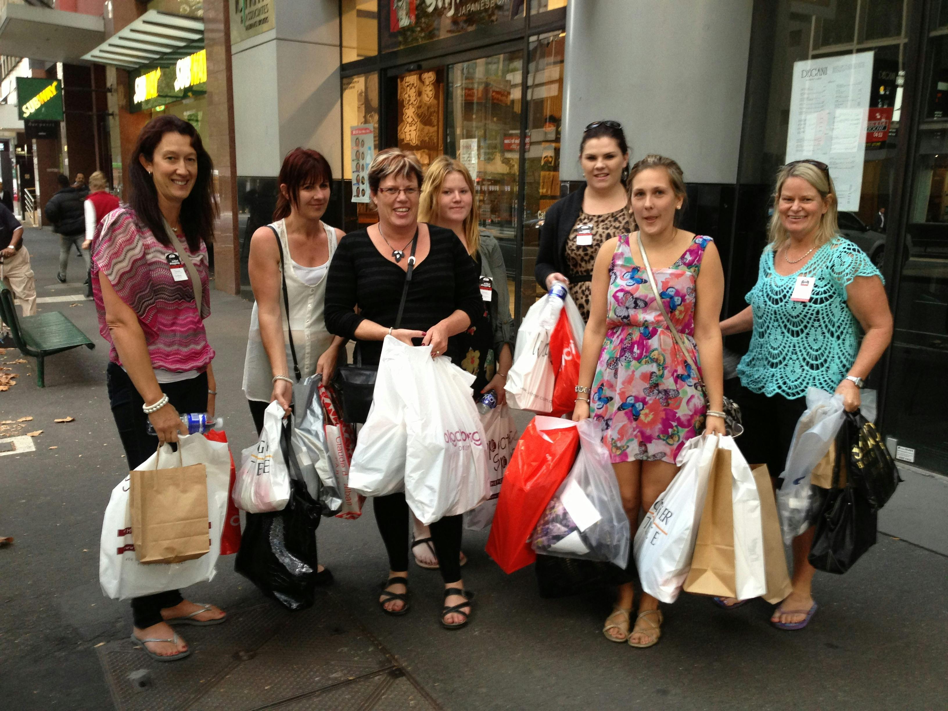 A group of women holding shopping bags
