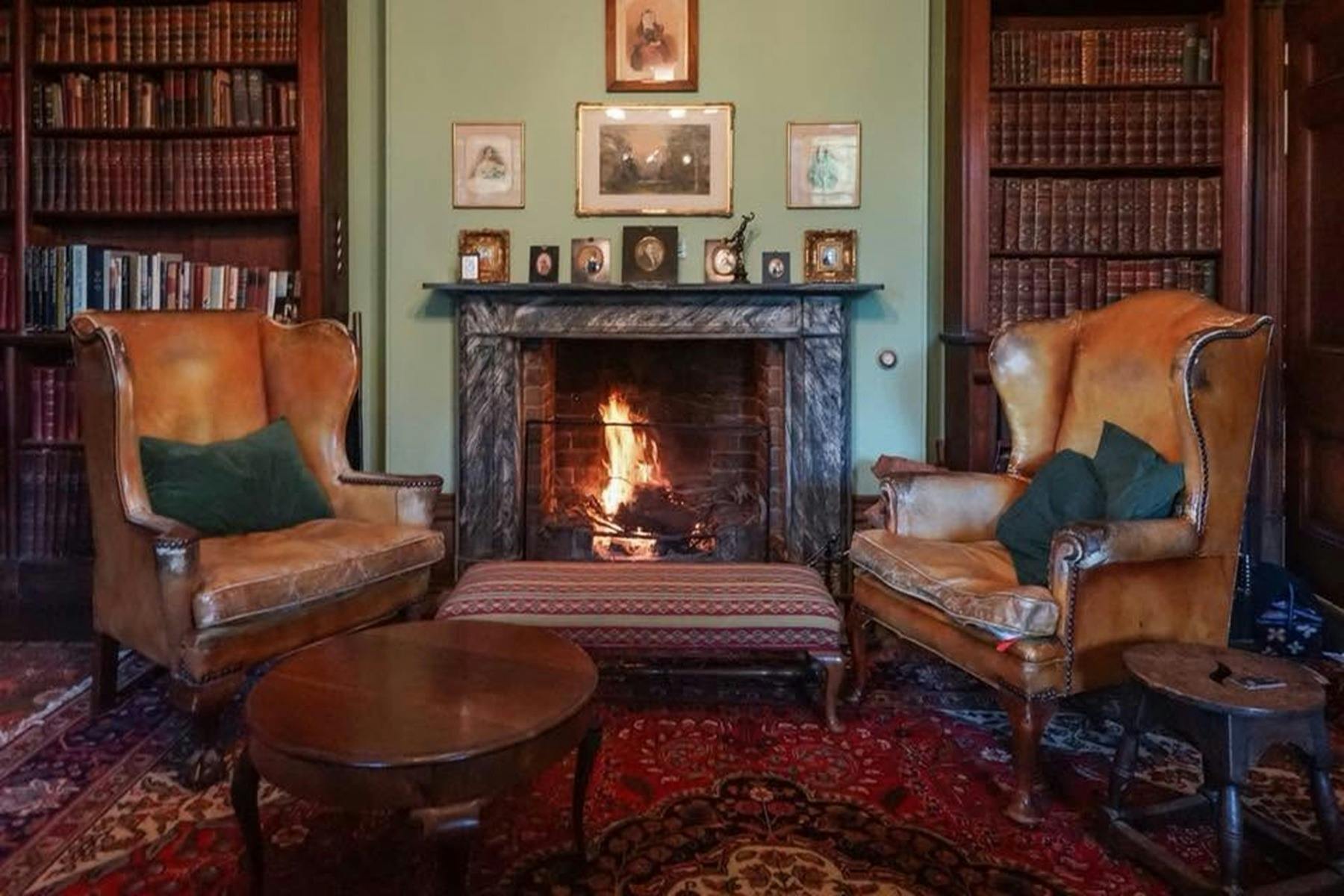 2leather chairs by a fire place