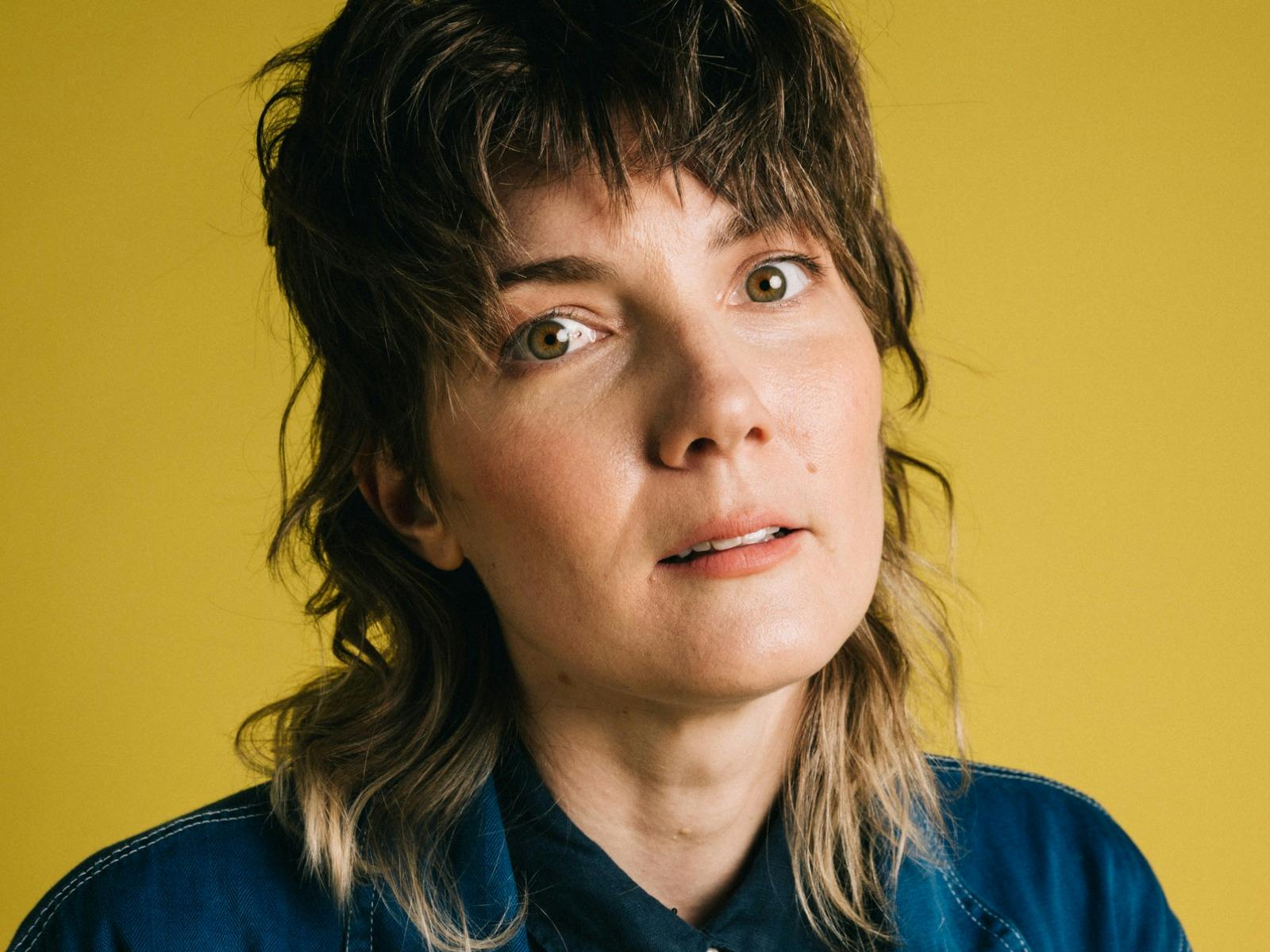 Head shot of Grace Hogan with a yellow background