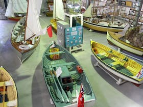 Restored open boats and memorabilia seen from the Museum bridge