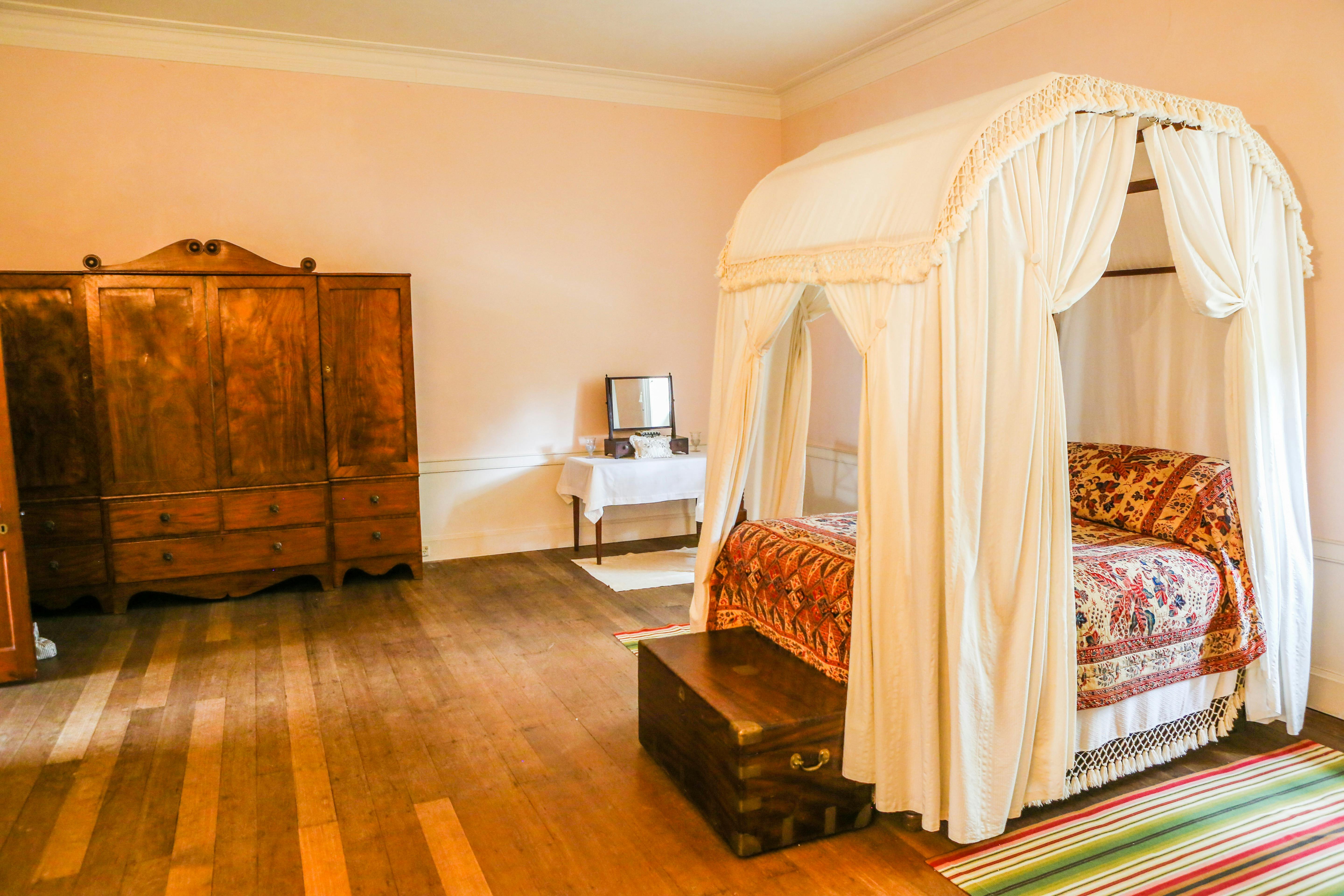 Interior bedroom with covered four poster bed