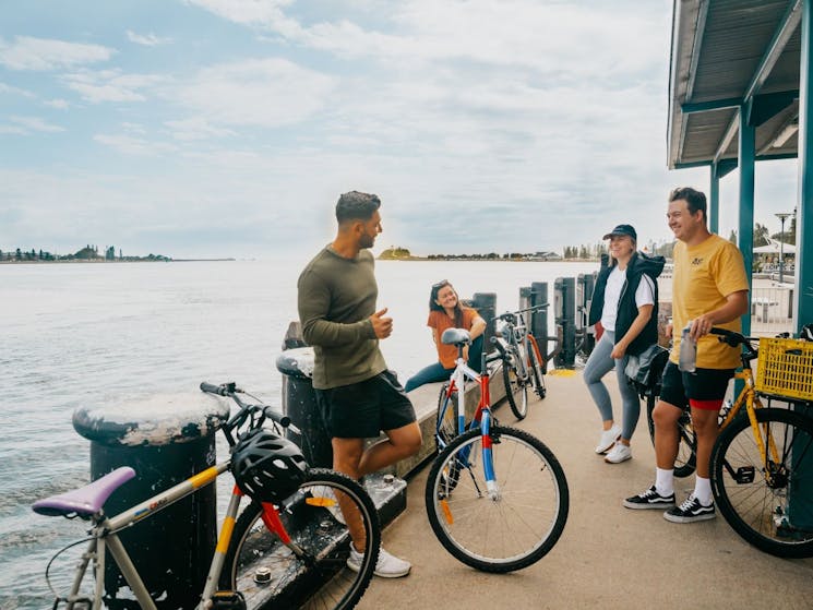 A tour group relaxing on the foreshore by the water