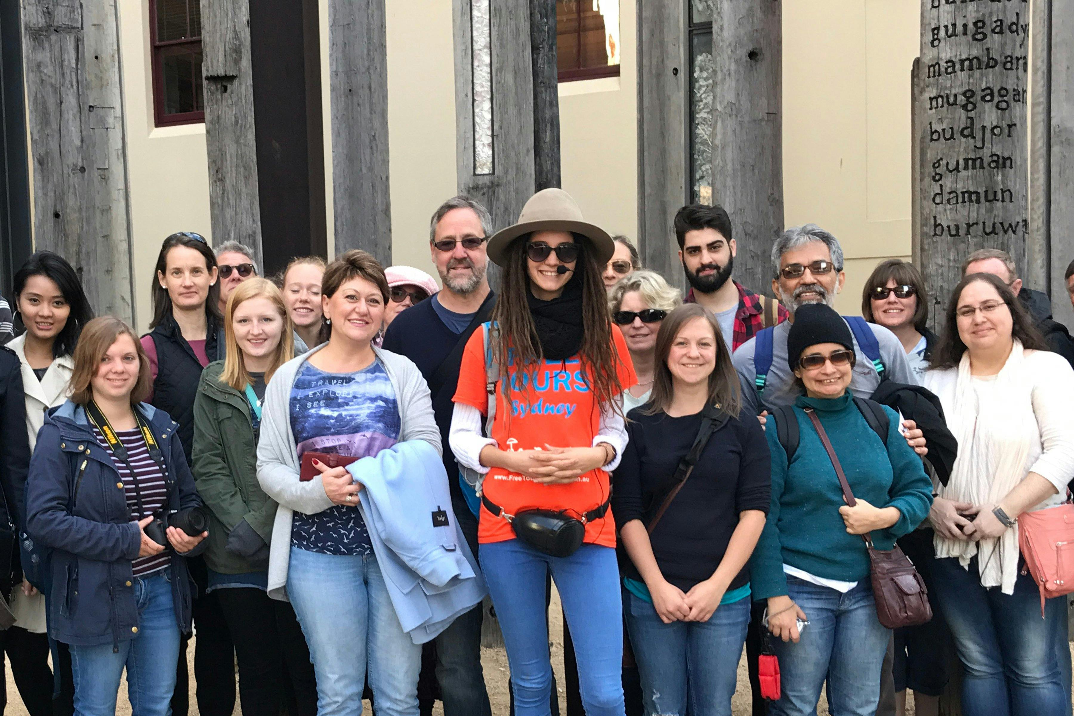 Sydney free walking tour group is taking a picture in front of Edge of the Trees art installation.
