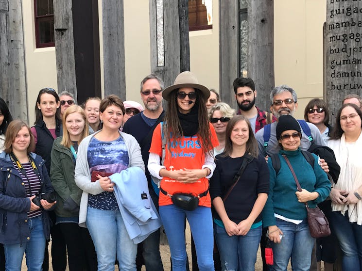 Sydney free walking tour group is taking a picture in front of Edge of the Trees art installation.