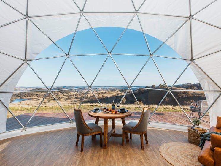 Panoramic window view looking outside of glamping dome