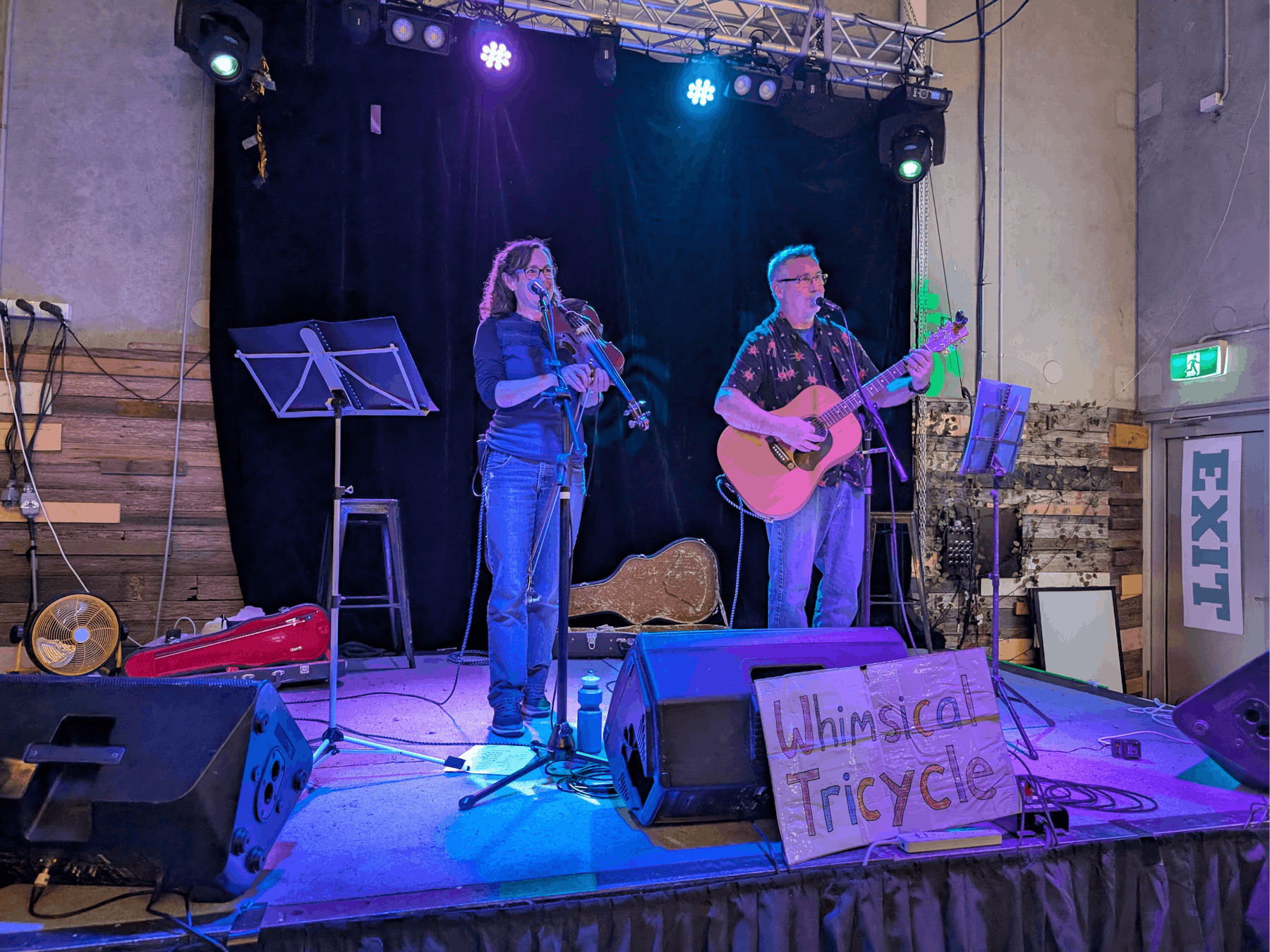 Female violinist and male guitarist on stage