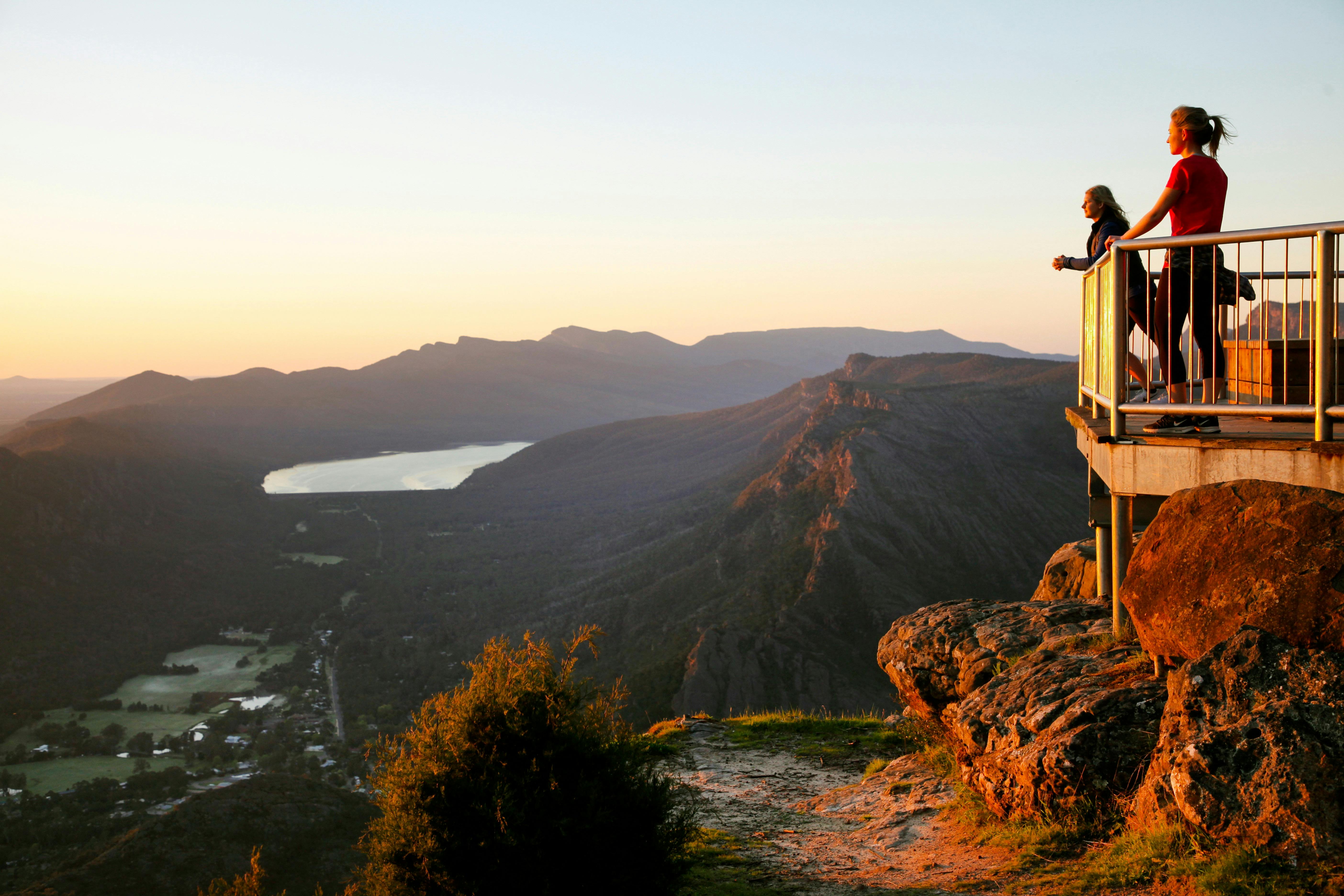 People overlooking Halls Gap from behind a barrier at Boroka Lookout