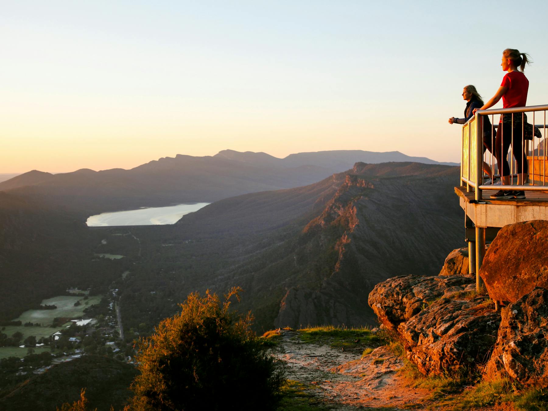 People overlooking Halls Gap from behind a barrier at Boroka Lookout