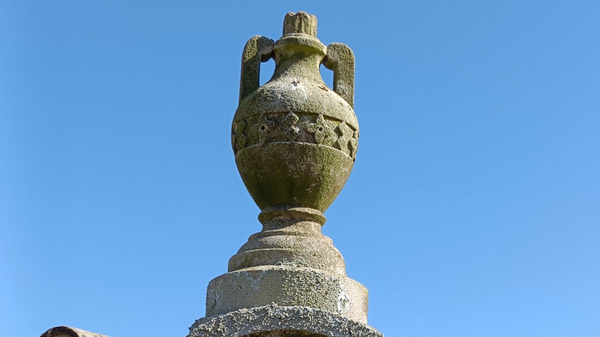 A cemetery monument with two hands clasped together