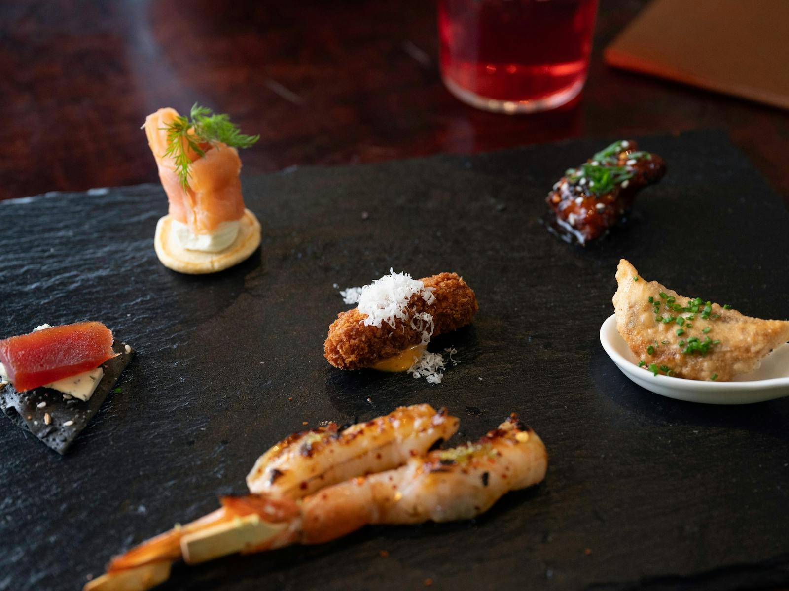 selection of small bites on a slate platter