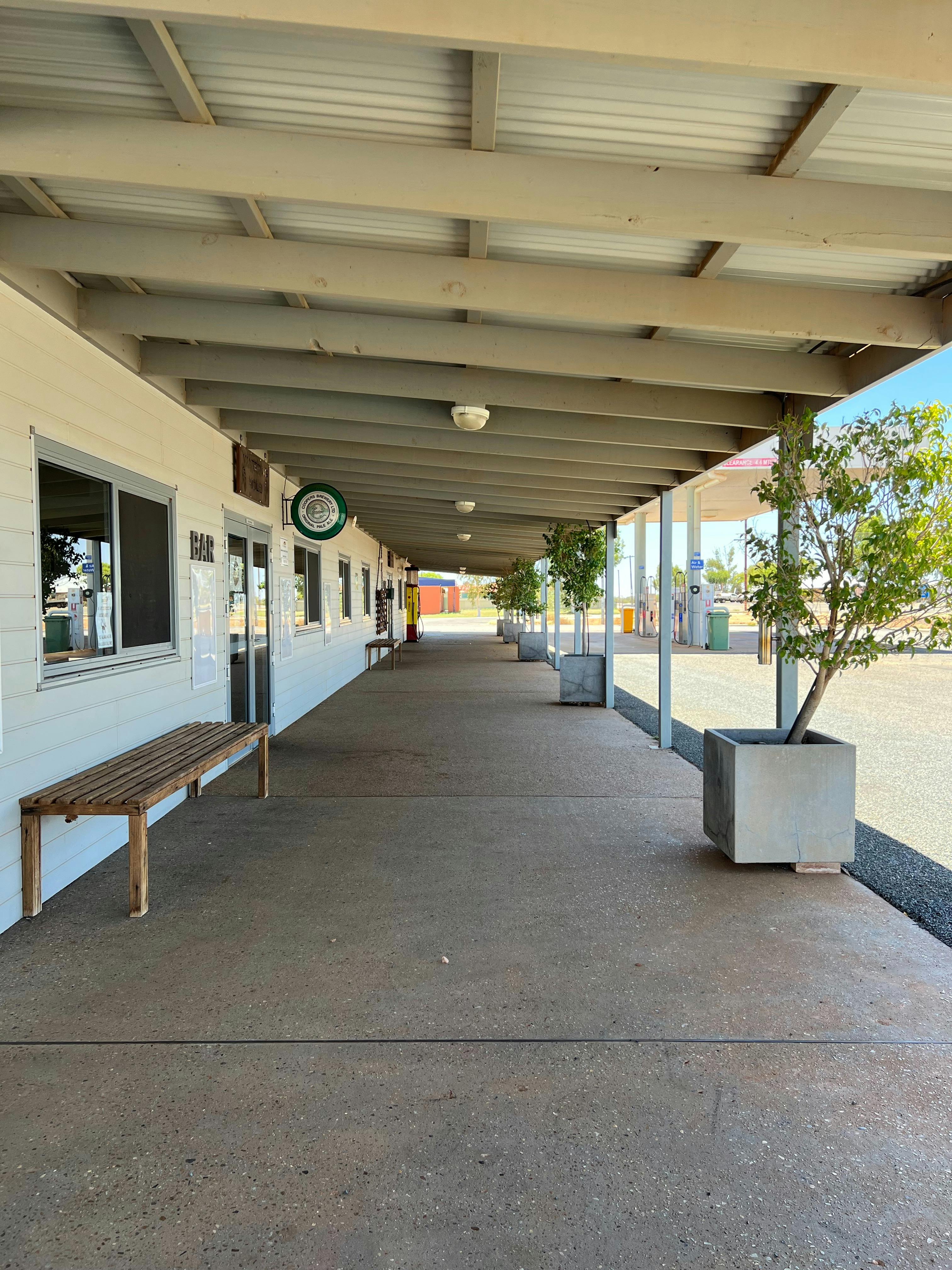 Seating and plants under the large verandah at front of Gascoyne Junction Pub and Tourist Park