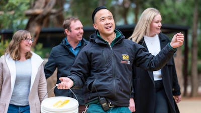 4 Guests are following a Jamala tour guide through the zoo.