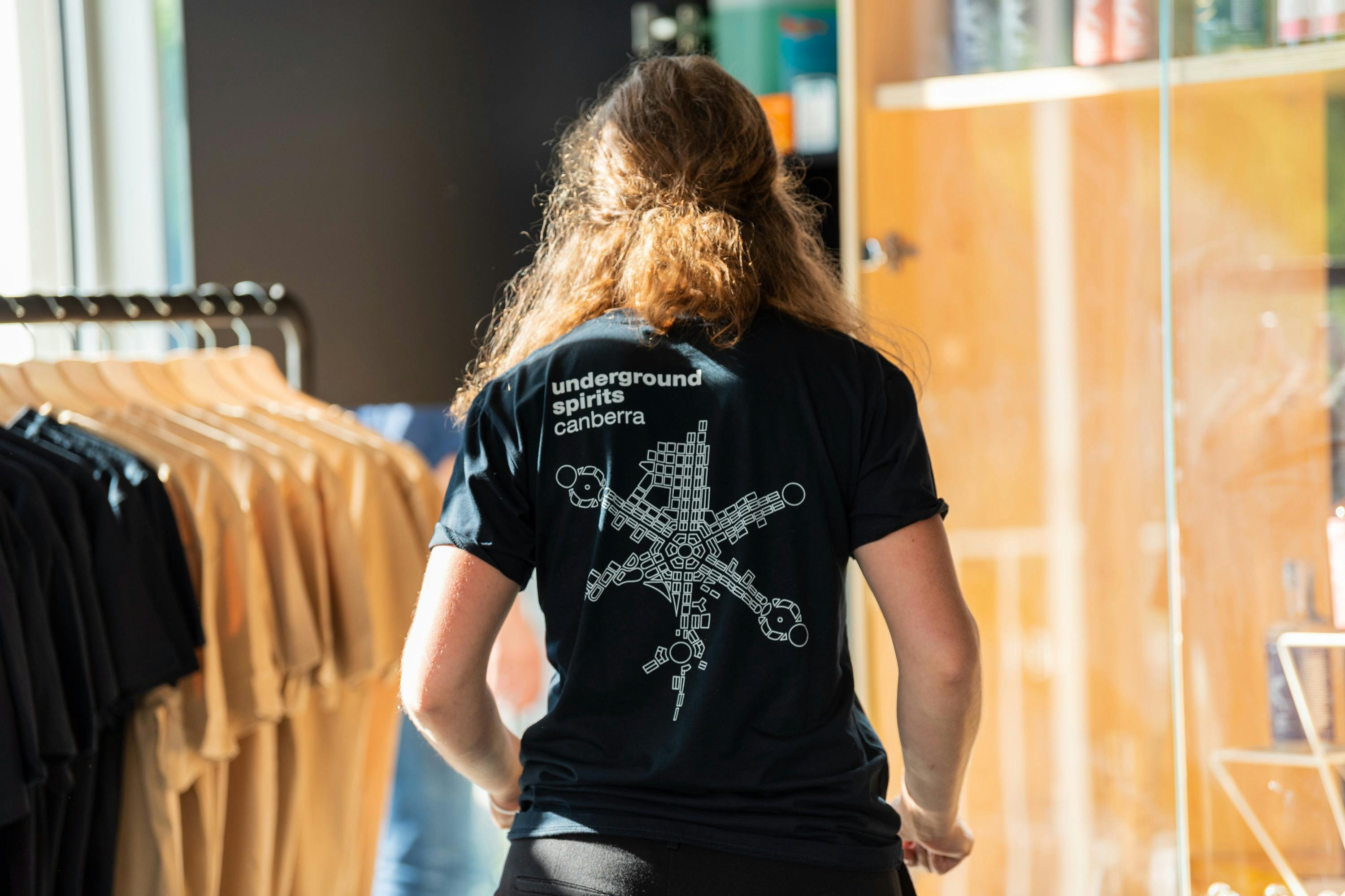 Figure wearing Underground Spirits T-shirt showing the logo