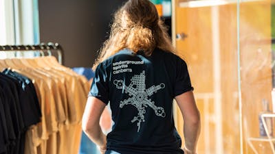 Figure wearing Underground Spirits T-shirt showing the logo