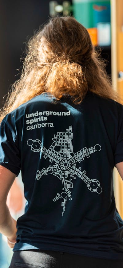Figure wearing Underground Spirits T-shirt showing the logo
