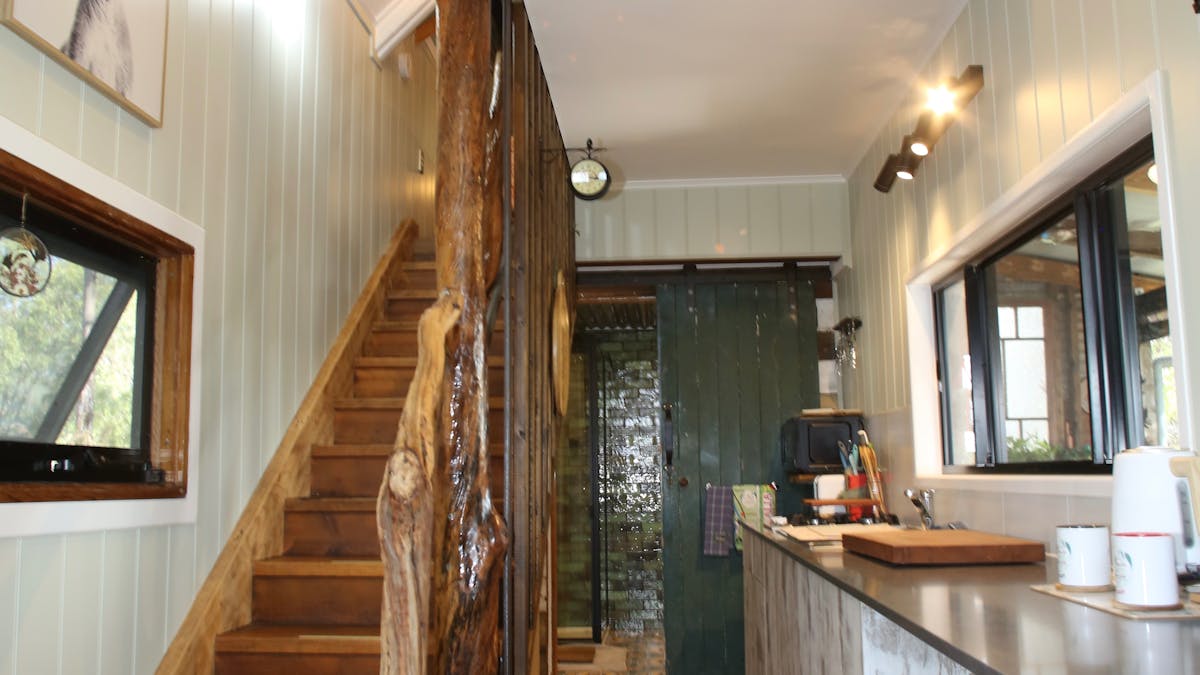 Staircase, kitchenette area with view into bathroom