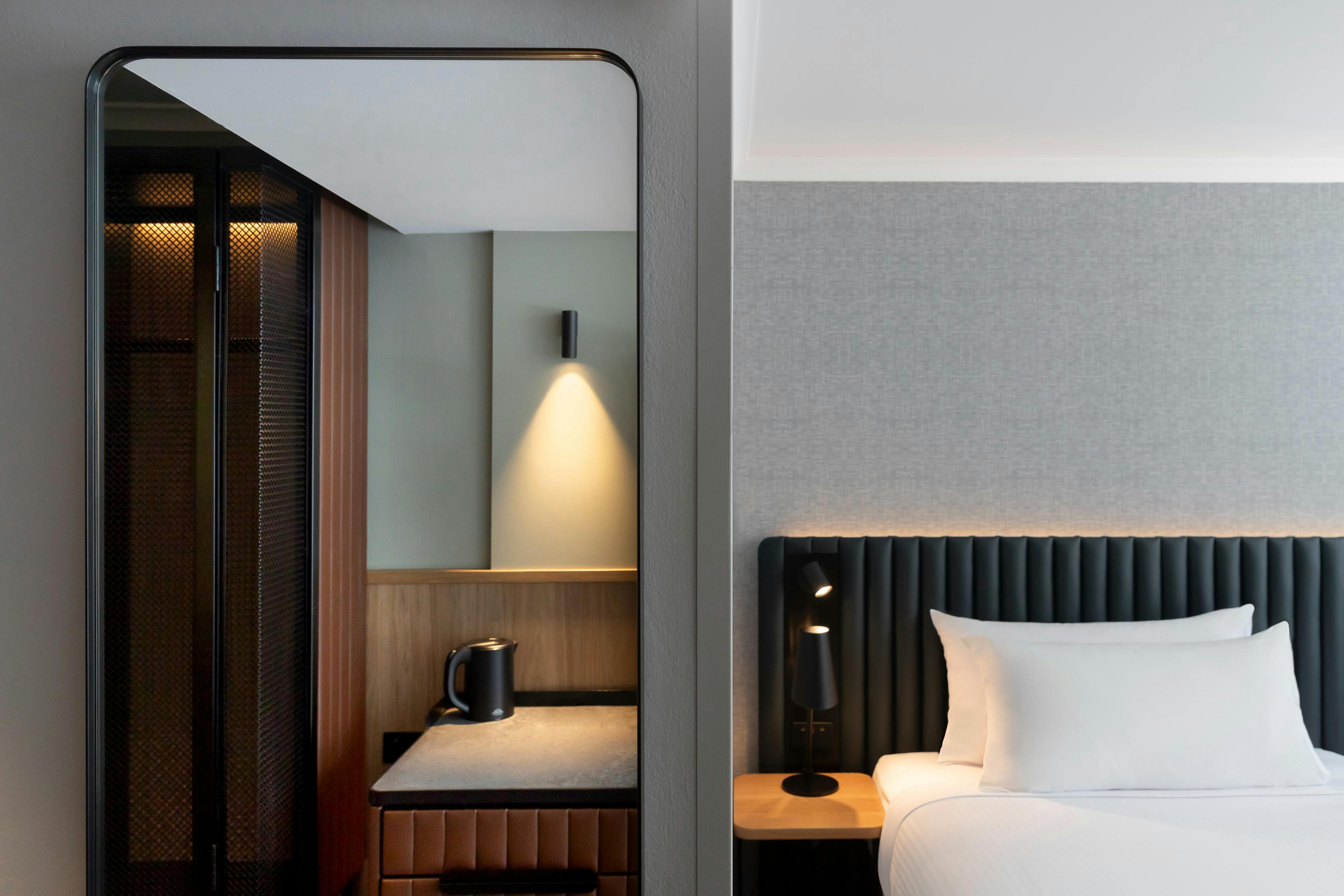 Picture of the Bed, side table, kitchenette and mirror