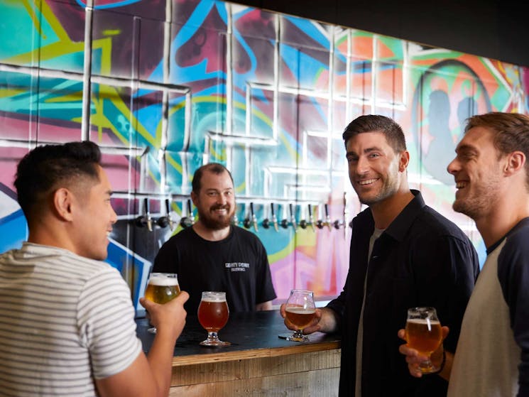 Guys at Bar mural on wall