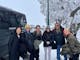 Guests standing in the snow on Mount Buller next to Double Black Alpine passenger van