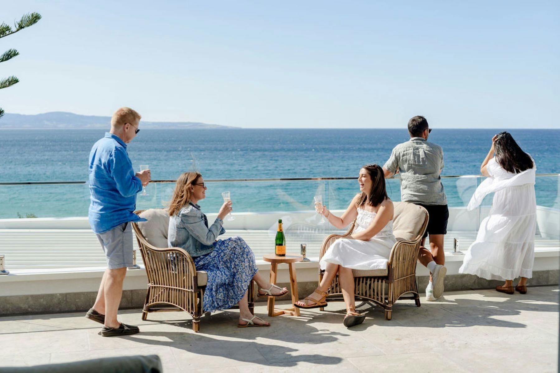 Image of a family enjoying panoramic ocean views on the top balcony
