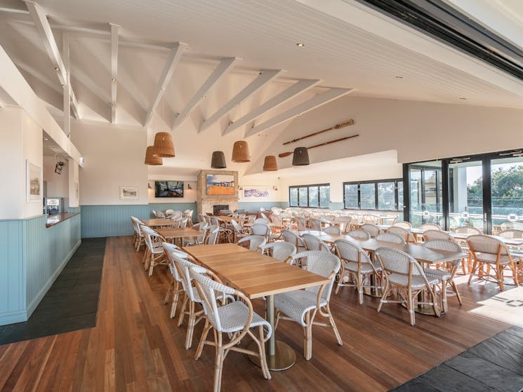 Indoor function and dining space, with wooden floors and tables and chairs