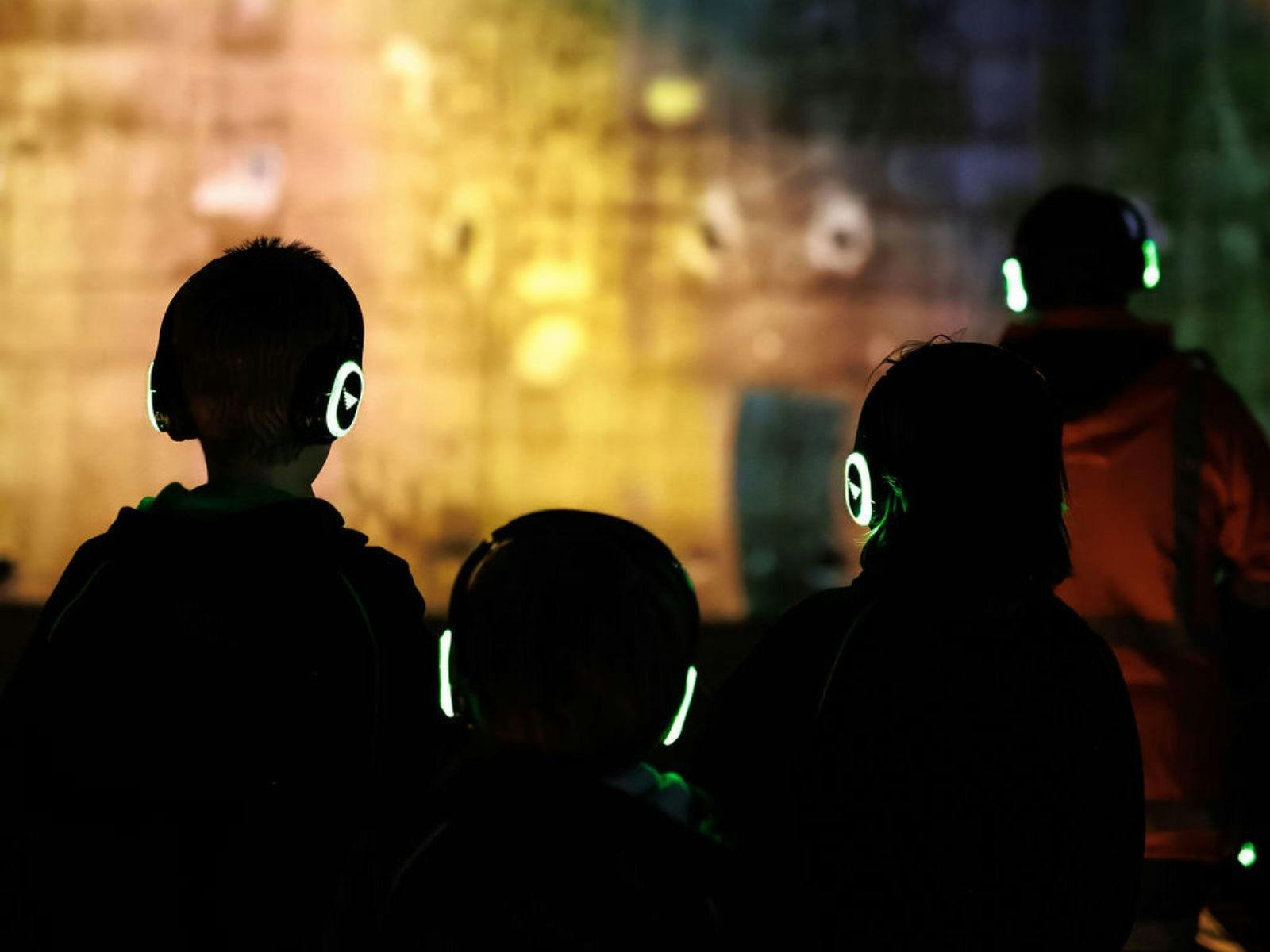 People watching Queenstown Lightshow wearing glowing headsets.