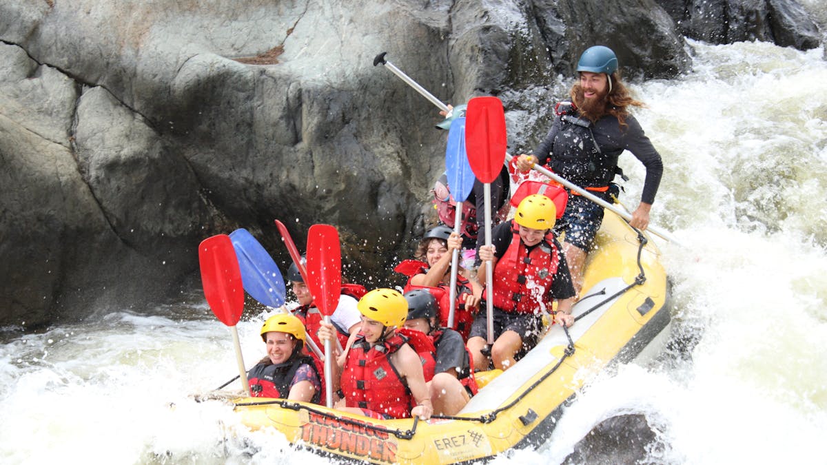 Exciting Action Shot of 8 going down a grade 3 rapid on the Barron Gorge National Park River