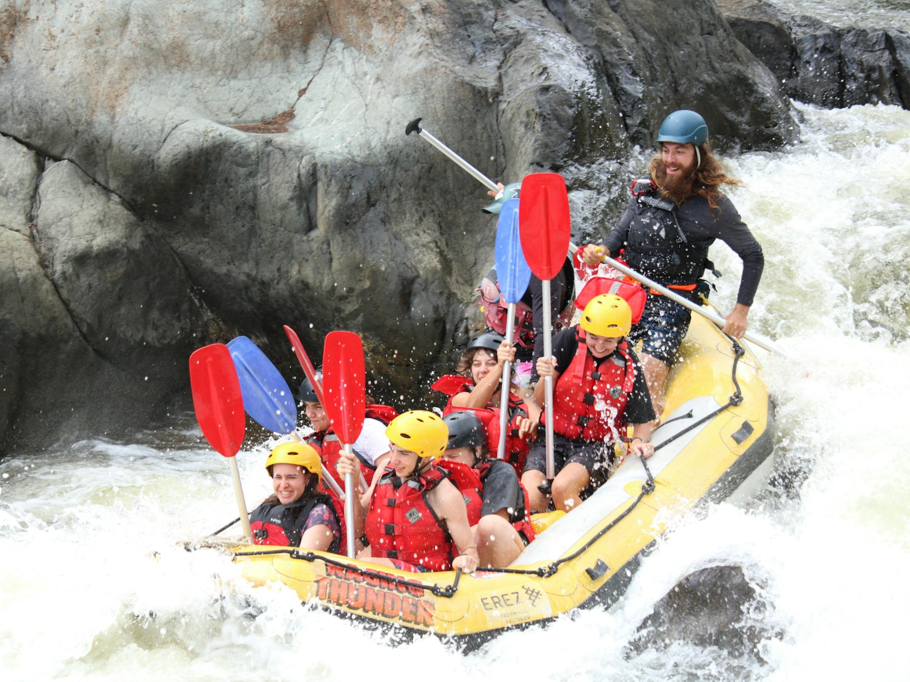 Exciting Action Shot of 8 going down a grade 3 rapid on the Barron Gorge National Park River