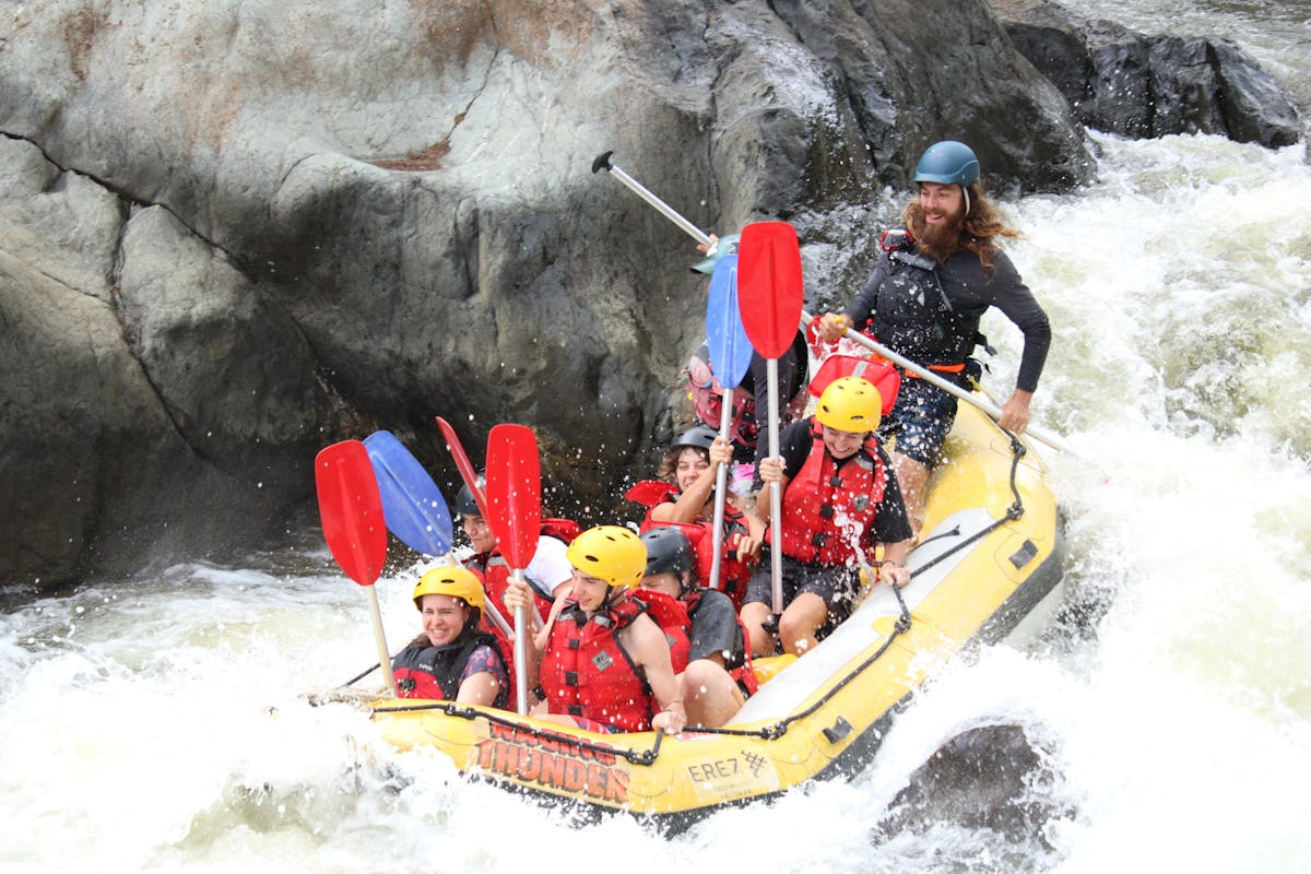 Exciting Action Shot of 8 going down a grade 3 rapid on the Barron Gorge National Park River