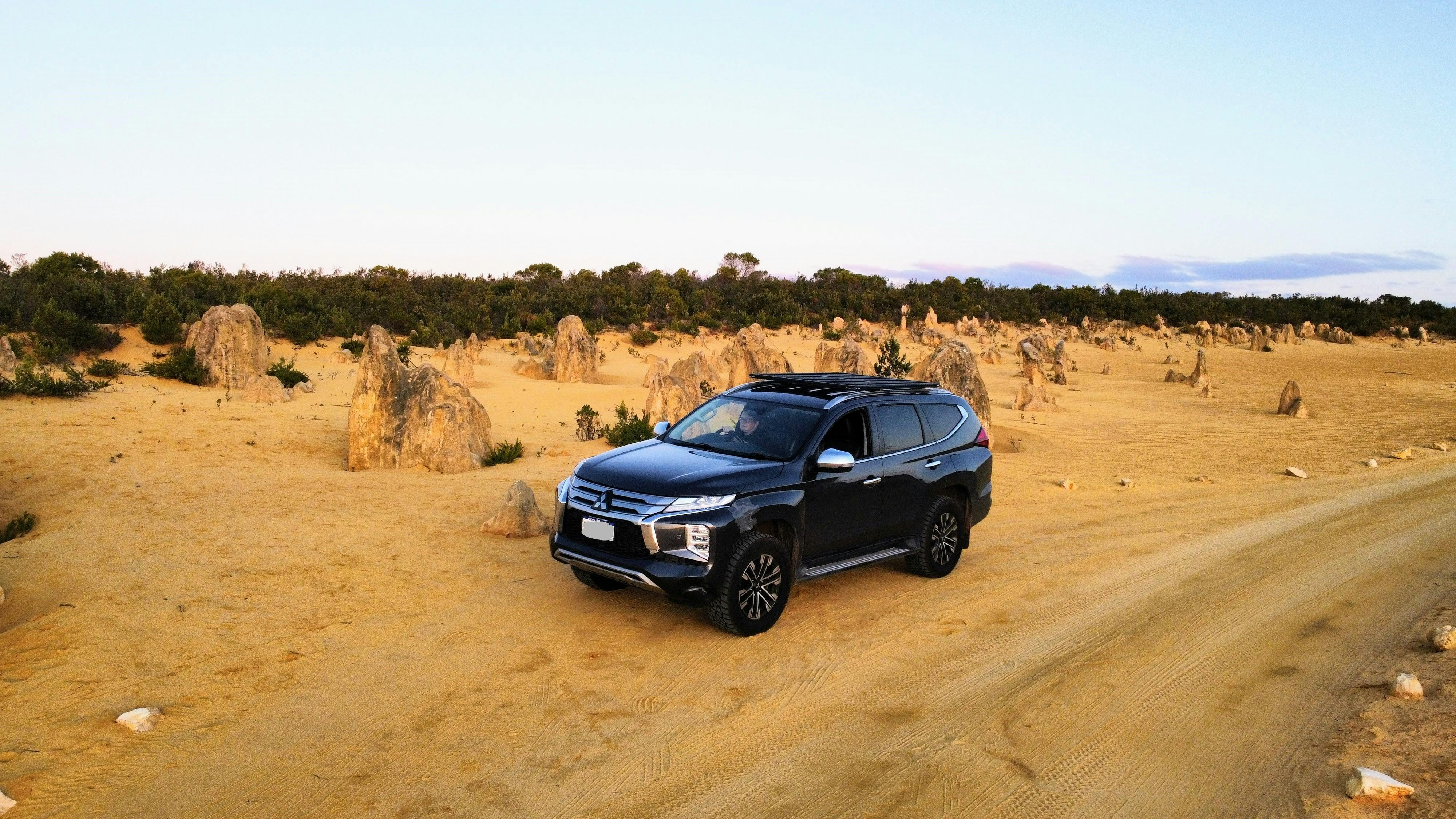Four wheel drive parked next to Pinnacles, a native rock formation