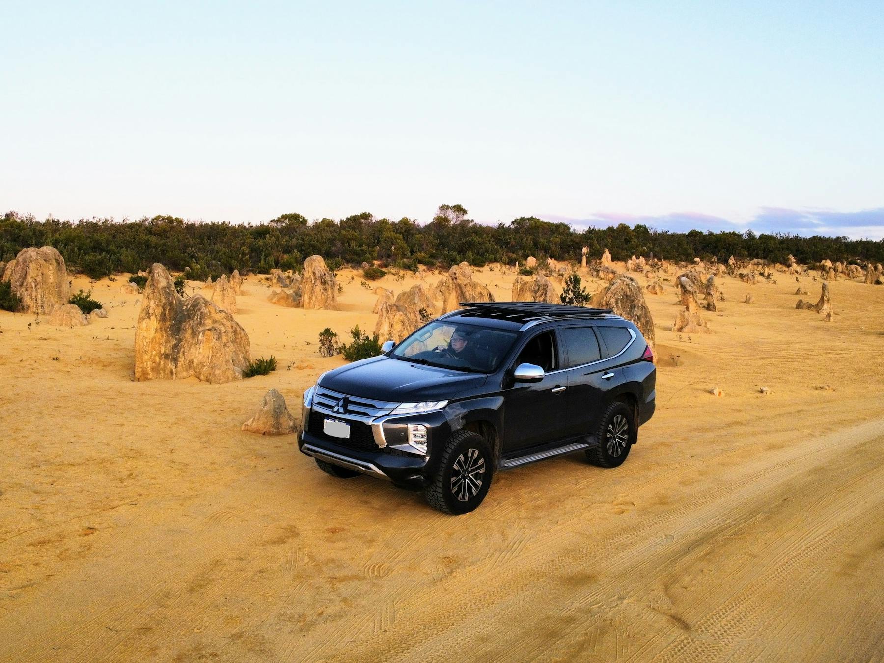 Four wheel drive parked next to Pinnacles, a native rock formation